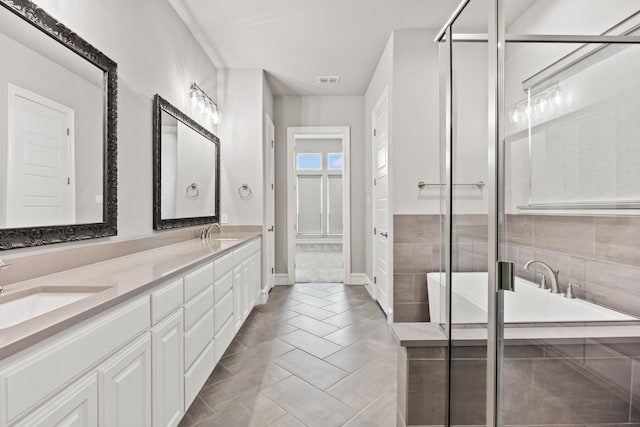 3416 Dovehill Dr, Northlake, TX 76247 - bathroom with a freestanding tub, double vanity, a stall shower, tile patterned floors, and baseboards