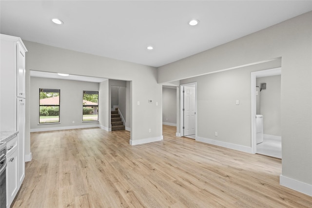 104 W 2nd St, Waxahachie, TX 75165 - unfurnished living room featuring stairway, light wood-style flooring, recessed lighting, and baseboards
