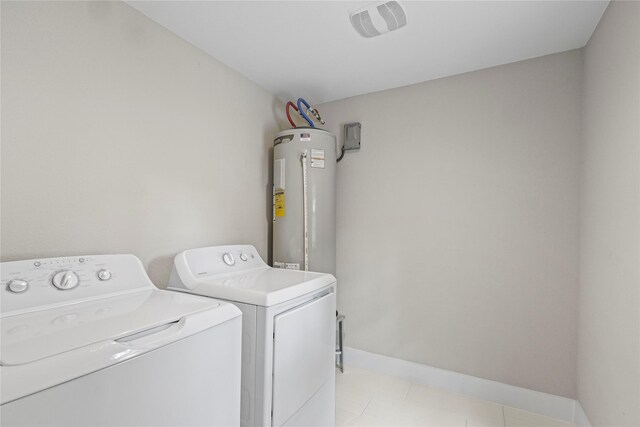 104 W 2nd St, Waxahachie, TX 75165 - washroom featuring water heater, washer and dryer, baseboards, and light tile patterned flooring