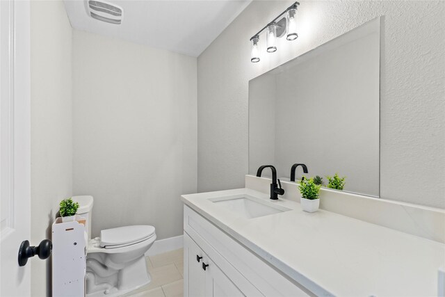 104 W 2nd St, Waxahachie, TX 75165 - bathroom with toilet, vanity, and tile patterned flooring