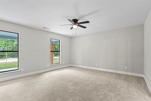 104 W 2nd St, Waxahachie, TX 75165 - spare room with healthy amount of natural light, a ceiling fan, baseboards, and carpet