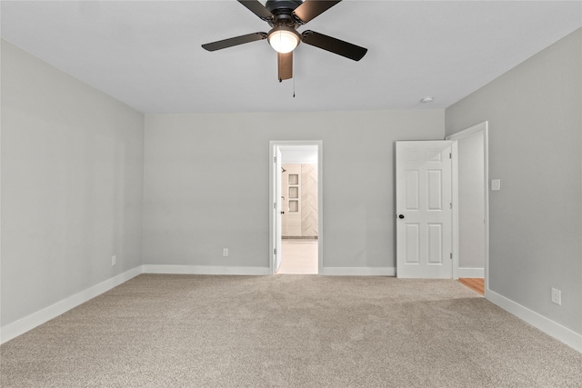 104 W 2nd St, Waxahachie, TX 75165 - unfurnished bedroom with carpet, baseboards, connected bathroom, and a ceiling fan