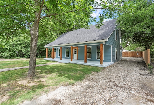 104 W 2nd St, Waxahachie, TX 75165 - view of front facade with covered porch, a shingled roof, and driveway