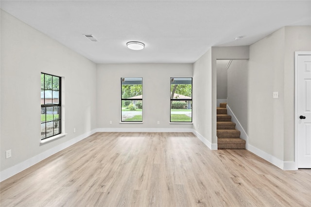 104 W 2nd St, Waxahachie, TX 75165 - empty room with plenty of natural light, light wood finished floors, stairs, and baseboards