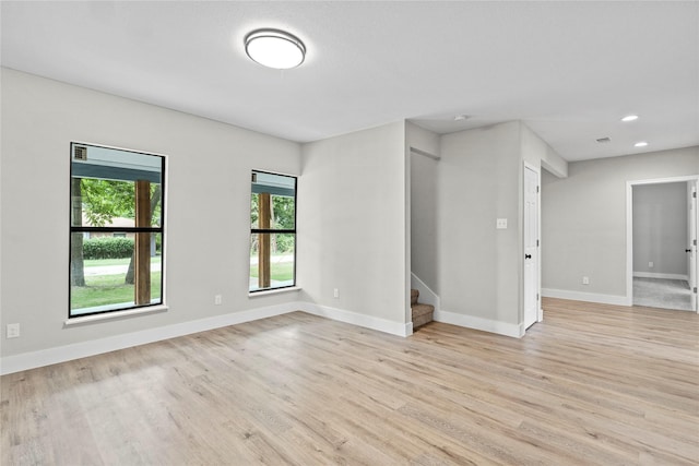 104 W 2nd St, Waxahachie, TX 75165 - spare room featuring light wood-style floors, stairway, baseboards, and recessed lighting