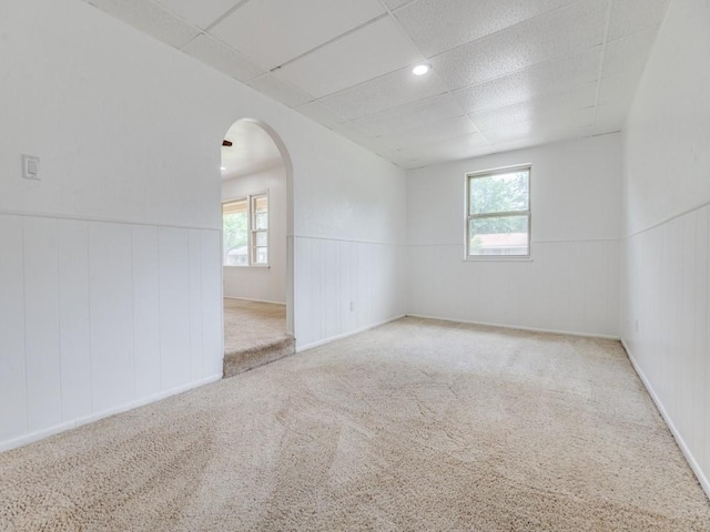 5512 Dennis Ave, Fort Worth, TX 76114 - carpeted spare room with arched walkways, a wainscoted wall, and a paneled ceiling