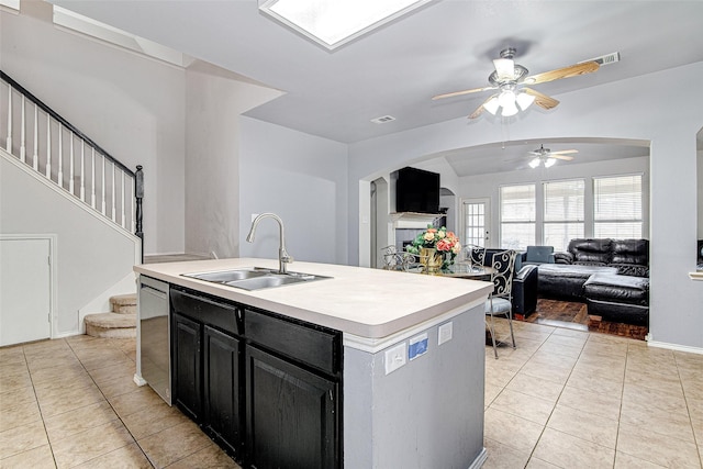 4621 Maple Hill Dr, Fort Worth, TX 76123 - kitchen featuring a sink, dishwasher, light tile patterned flooring, dark cabinets, and arched walkways