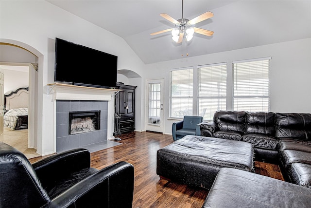 4621 Maple Hill Dr, Fort Worth, TX 76123 - living room with arched walkways, lofted ceiling, ceiling fan, wood finished floors, and a fireplace