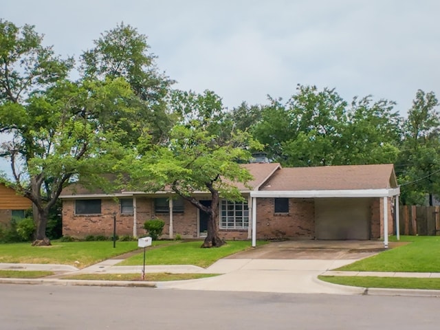1418 Royal Dr, Kaufman, TX 75142 - ranch-style house with brick siding, concrete driveway, and an attached carport
