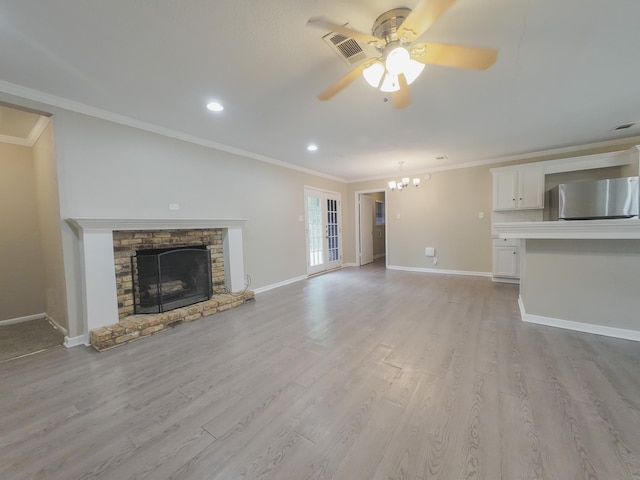1418 Royal Dr, Kaufman, TX 75142 - unfurnished living room featuring a ceiling fan, ornamental molding, a stone fireplace, light wood finished floors, and baseboards