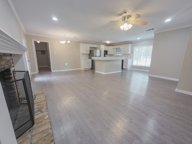 1418 Royal Dr, Kaufman, TX 75142 - unfurnished living room featuring ornamental molding, a chandelier, a fireplace, a ceiling fan, and baseboards
