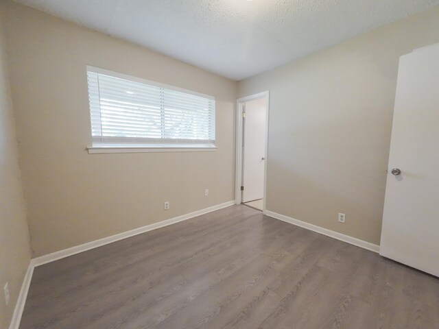 1418 Royal Dr, Kaufman, TX 75142 - unfurnished room featuring wood finished floors and baseboards