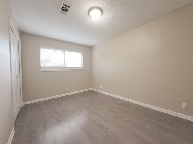 1418 Royal Dr, Kaufman, TX 75142 - unfurnished bedroom featuring dark wood-style flooring, a closet, and baseboards