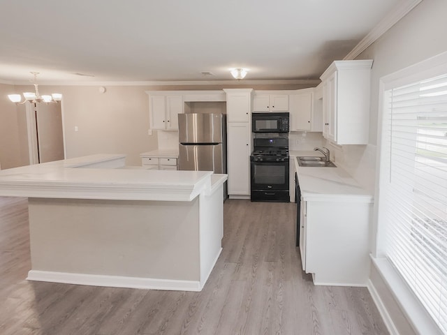 1418 Royal Dr, Kaufman, TX 75142 - kitchen with black appliances, a sink, white cabinets, light countertops, and light wood finished floors