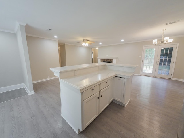 1418 Royal Dr, Kaufman, TX 75142 - kitchen with ornamental molding, open floor plan, a ceiling fan, light wood-style floors, and a center island