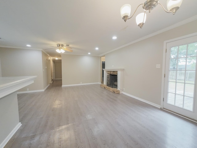 1418 Royal Dr, Kaufman, TX 75142 - unfurnished living room featuring ornamental molding, a stone fireplace, recessed lighting, light wood-style flooring, and baseboards