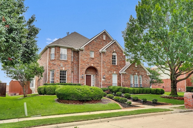 6628 Gray Wolf Dr, Plano, TX 75024 - traditional-style house featuring a front yard and brick siding