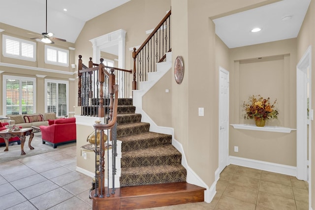 6628 Gray Wolf Dr, Plano, TX 75024 - staircase with tile patterned floors, a ceiling fan, plenty of natural light, baseboards, and high vaulted ceiling