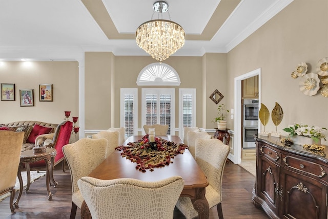 6628 Gray Wolf Dr, Plano, TX 75024 - dining space featuring a chandelier, a tray ceiling, dark wood-style floors, and crown molding
