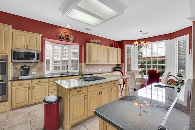 6628 Gray Wolf Dr, Plano, TX 75024 - kitchen featuring appliances with stainless steel finishes, a sink, plenty of natural light, and a chandelier