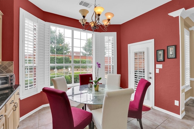 6628 Gray Wolf Dr, Plano, TX 75024 - dining room with a chandelier, light tile patterned floors, and baseboards