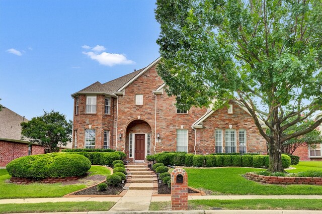 6628 Gray Wolf Dr, Plano, TX 75024 - traditional-style home featuring brick siding and a front lawn