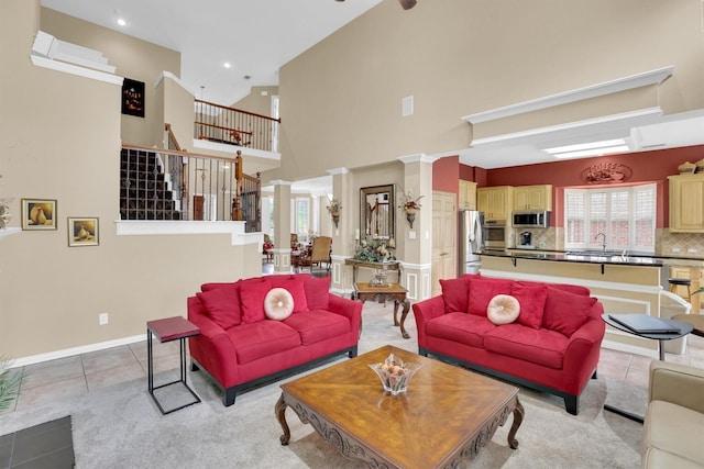 6628 Gray Wolf Dr, Plano, TX 75024 - living area with stairs, a towering ceiling, light tile patterned flooring, recessed lighting, and baseboards