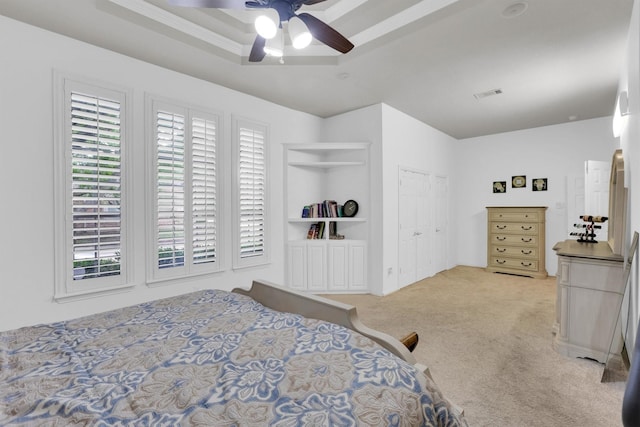 6628 Gray Wolf Dr, Plano, TX 75024 - bedroom featuring multiple windows, light colored carpet, a ceiling fan, and a raised ceiling
