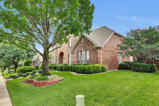 6628 Gray Wolf Dr, Plano, TX 75024 - traditional-style home with brick siding, a front lawn, and a shingled roof