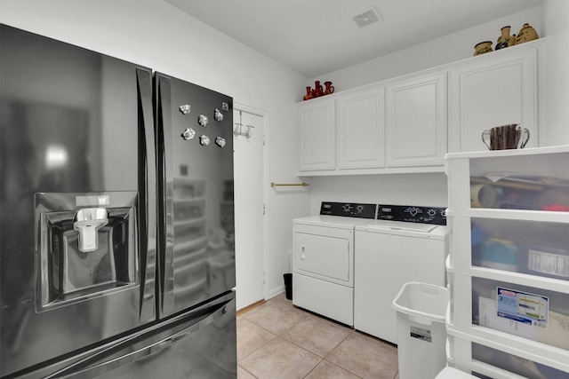 6628 Gray Wolf Dr, Plano, TX 75024 - laundry room featuring independent washer and dryer, light tile patterned flooring, and cabinet space