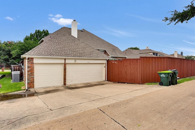 6628 Gray Wolf Dr, Plano, TX 75024 - view of home's exterior with cooling unit, driveway, an attached garage, brick siding, and a shingled roof