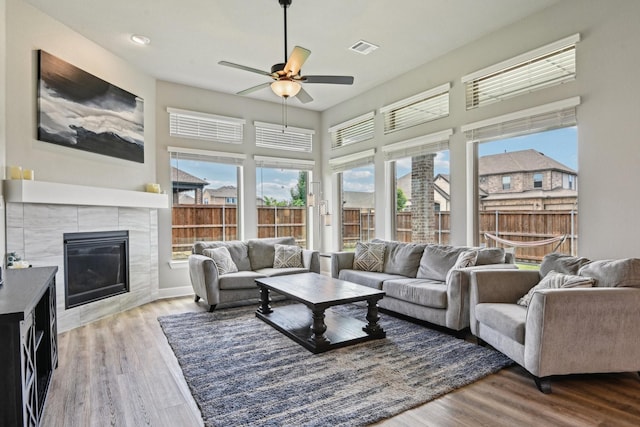 3200 Julian St, Mansfield, TX 76063 - living room with ceiling fan, wood finished floors, a tile fireplace, and a towering ceiling