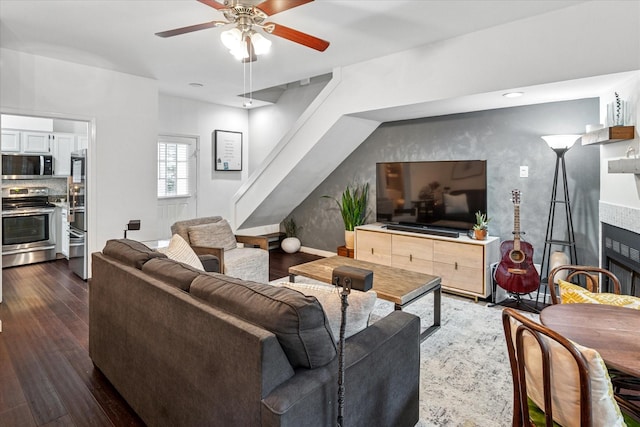 4116 Cole Ave Unit 302, Dallas, TX 75204 - living room featuring dark wood-style floors, a ceiling fan, and a tile fireplace