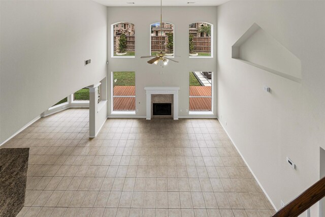204 Forestview Rd, Hickory Creek, TX 75065 - unfurnished living room featuring a ceiling fan, healthy amount of natural light, baseboards, and a high ceiling