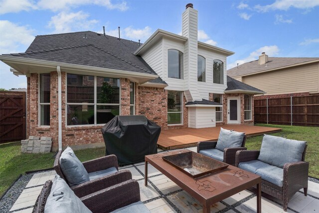 204 Forestview Rd, Hickory Creek, TX 75065 - fenced backyard with a wooden deck, outdoor lounge area, a grill, and a patio area