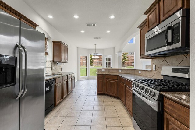 204 Forestview Rd, Hickory Creek, TX 75065 - kitchen featuring stainless steel appliances, backsplash, recessed lighting, stone countertops, and a sink
