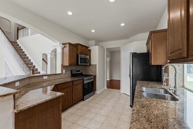204 Forestview Rd, Hickory Creek, TX 75065 - kitchen featuring appliances with stainless steel finishes, a sink, tasteful backsplash, light stone countertops, and recessed lighting