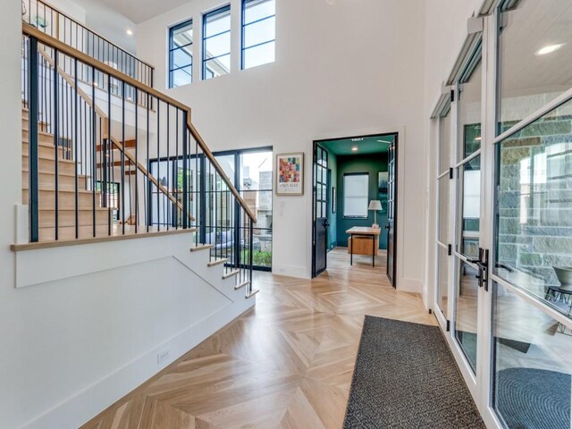 6443 Ellsworth Ave, Dallas, TX 75214 - entrance foyer with french doors, baseboards, plenty of natural light, stairway, and a towering ceiling