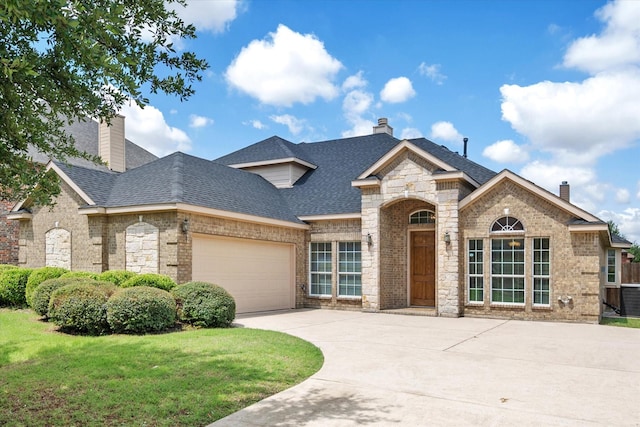 304 Adobe Lilly Ct, Mansfield, TX 76063 - french country home featuring a chimney, a shingled roof, an attached garage, and driveway