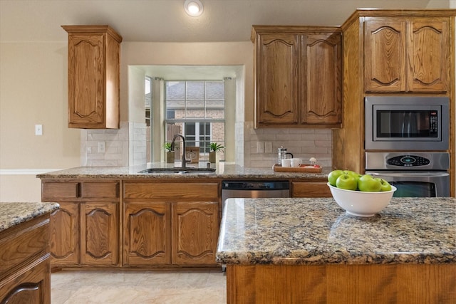304 Adobe Lilly Ct, Mansfield, TX 76063 - kitchen with a sink, appliances with stainless steel finishes, stone counters, and backsplash