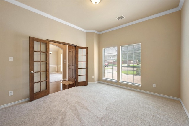 304 Adobe Lilly Ct, Mansfield, TX 76063 - carpeted empty room featuring french doors, crown molding, arched walkways, and baseboards