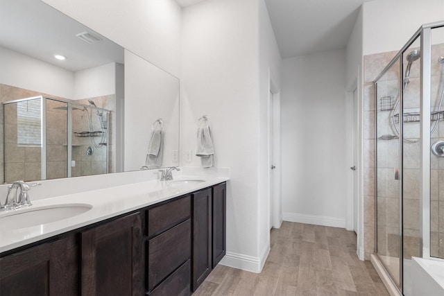 3004 Aransas Ave, Aubrey, TX 76227 - full bath with a stall shower, wood finished floors, double vanity, and baseboards