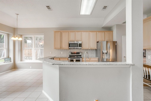2604 Briarcrest Dr, Burleson, TX 76028 - kitchen featuring stainless steel appliances, light tile patterned floors, plenty of natural light, and light brown cabinetry