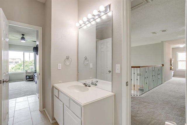 2604 Briarcrest Dr, Burleson, TX 76028 - bathroom featuring vanity, ceiling fan, a textured ceiling, baseboards, and tile patterned floors