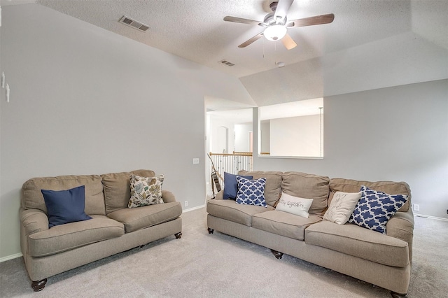 2604 Briarcrest Dr, Burleson, TX 76028 - carpeted living room with vaulted ceiling, ceiling fan, a textured ceiling, and baseboards