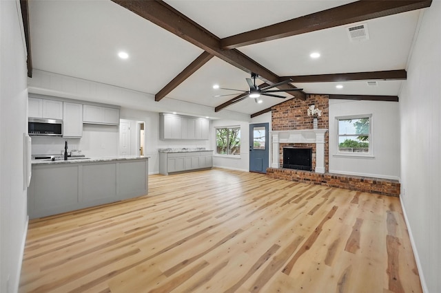 9813 Bancroft Dr, Benbrook, TX 76126 - unfurnished living room with light wood-type flooring, ceiling fan, a fireplace, recessed lighting, and baseboards