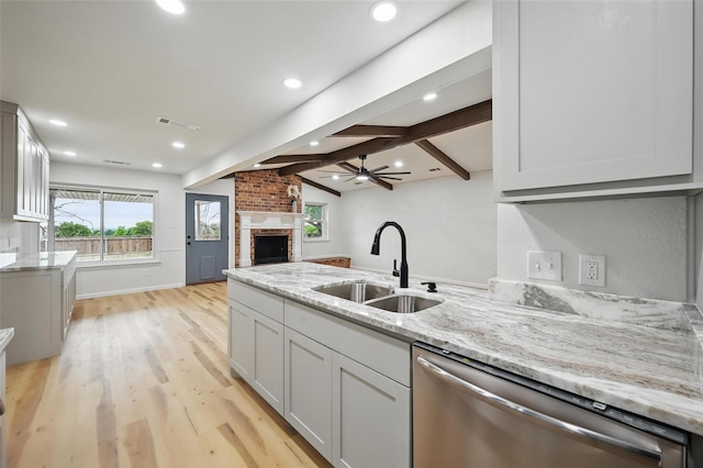 9813 Bancroft Dr, Benbrook, TX 76126 - kitchen with stainless steel dishwasher, a sink, light stone countertops, light wood-style flooring, and recessed lighting