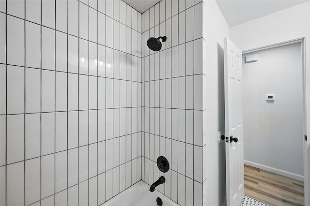 9813 Bancroft Dr, Benbrook, TX 76126 - bathroom with shower / washtub combination, wood finished floors, and baseboards