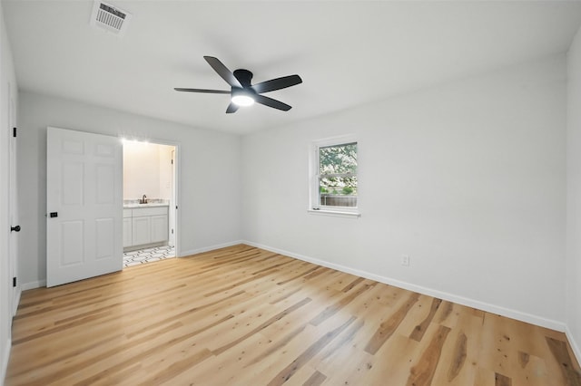 9813 Bancroft Dr, Benbrook, TX 76126 - unfurnished bedroom featuring light wood-style flooring, baseboards, a sink, and connected bathroom