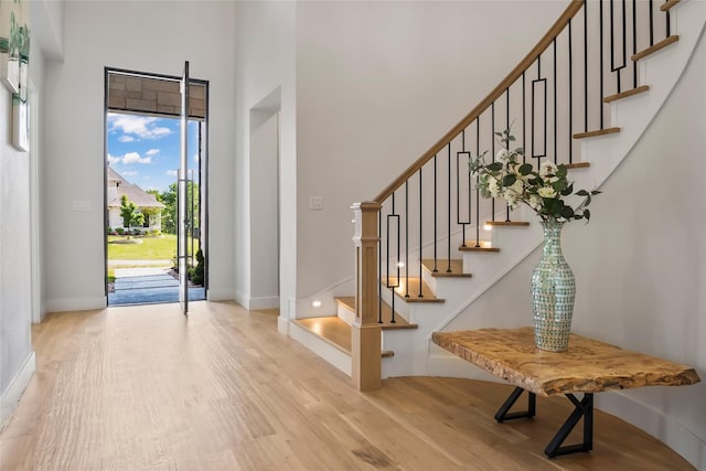 1209 Hicks Trl, Lucas, TX 75002 - foyer with light wood-type flooring, baseboards, a towering ceiling, and stairway